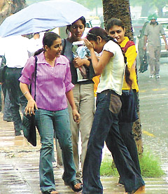 Girls trying to protect themselves from the sudden showers that lashed the Capital on Wednesday