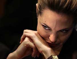 Actress Angelina Jolie glances towards photographers