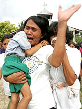 A Filipino mother cries during a mass burial of food poisoning victims in the San Jose town chapel in Bohol province, central Philippines, on Thursday.