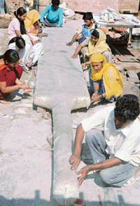 Members of Vishnus family give finishing touches to a 21-foot-long bat. 