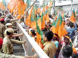 The police tries to control BJP workers during their Dispur gherao in protest against the alleged failure of the Congress government in the state, in Guwahati on Friday.