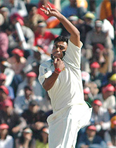 Danish Kaneria bowls during the fourth days play of the first Test in Mohali on Friday