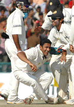 Team-mates congratulate Anil Kumble after he dismissed Pakistans Mohammad Sami to pick up his 450th Test wicket on the fifth day of the Mohali Test on Saturday