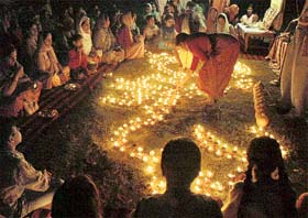 Women light earthen lamps during the deep yagya on the concluding of the yoga camp at Sector 46-C, Chandigarh