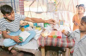 To raise money for his education, Mukesh Kumar sells eatables and beedis while preparing for examination at Kumhar Colony, Sector 25, Chandigarh