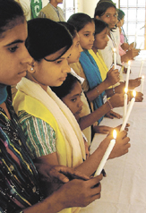 Girls from different states participating in a candlelight prayer at a seminar, Nai Subah-Delhi 2005, organised by Campaign Against Child Labour at Ambedkar Bhavan in the Capital on Sunday. 
