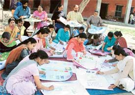 Teachers learn new techniques to teach students at a seminar held in a multi-purpose school 