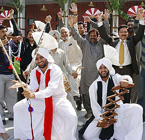 Pakistani cricket fans shake their legs along with bhangra dancers in Jalandhar on Sunday