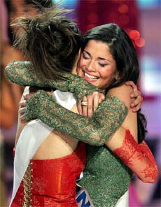 Shermine Shahrivar of Germany hugs first runners-up Lyusya Tovmasyan of Armenia after winning the Miss Europe title in Paris