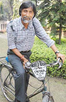 Ram Chander Biswas, travelling around the world on his bicycle for the past 23 years, poses for a picture in Sector 17, Chandigarh