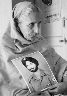 Surjit Kaur with a photograph of her husband, Capt Bhajan Singh, in Mohali