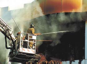 A fireman trying to douse the flames at Kirti Nagar timber market in the Capital
