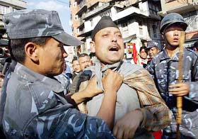 A Nepali policeman arrests a demonstrator in Kathmandu on Monday.