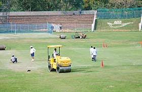 Ground workers prepare the pitch of the Sector-16 cricket stadium for the coming semi-final match of the Ranji Trophy in Chandigarh