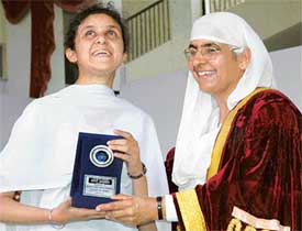 Principal of Master Tara Singh College presents a roll of honour to the best singer Monica Kalia at the convocation function of the college on Tuesday