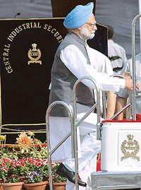 Prime Minister Manmohan Singh climbs the reviewing vehicle to inspect the 36th Raising Day parade on the CISF campus in Indirapuram (Ghaziabad) on Tuesday.
