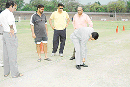 Umpires and officials for the Haryana versus Jharkhand Ranji Trophy semifinal inspect the pitch at the Cricket Stadium, Sector 16, Chandigarh, on Thursday.