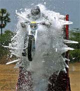 An Army officer performs a stunt through fluoroscent tubes at the 79th passing-out parade at the Officers Training Academy in Chennai on Friday.