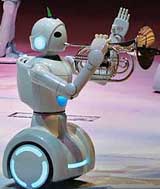 Toyota partner robot music band member plays trumpet and horn to welcome visitors at Toyota Group Pavilion during a press preview of the Aichi Expo 2005 in Nagakute, central Japan, on Saturday. The six-month Aichi Expo starts Friday next.
