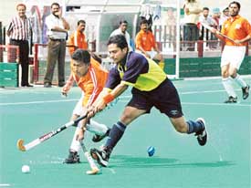 Players of AG and AG vie for honours in the All-India Inter Zonal Hockey Tournament held at Hockey Stadium, Sector 42, Chandigarh
