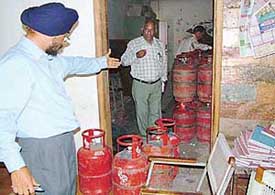 Food and supply officials during a raid at a showroom in Phase-I, Industrial Area, on Saturday