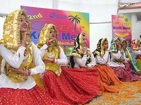 Artistes perform a folk dance at the national crafts mela in Karnal