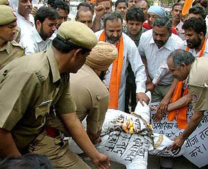 Activists of the Shiv Sena try to burn an effigy of US President George W. Bush, but are stopped from doing so by the police, during a demonstration in New Delhi on Saturday. 