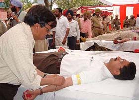 District police chief Kapil Dev donates blood at a camp organised by the police