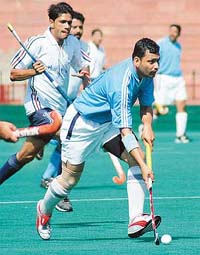 A player of AG Rajasthan moves with the ball against Delhi Audit at All-India Inter-Audit (IA&AD) Hockey Tournament in Chandigarh