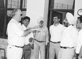 Mr Stuart Campbell, chief teaching professional of Sahara India Corporation, talks to Mr J.S. Cheema, Senior Vice-President, and staff members of the Chandigarh Golf Range in Chandigarh