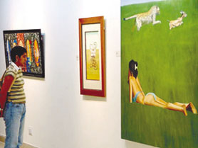 A girl having a close look at one of the paintings at Lalit Kala Akademi where 60 young artists of the country display their works at an exhibition Are we like this only? in the Capital on Sunday.