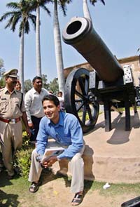 Bilal Musharraf, son of Pakistan President Pervez Musharraf, poses in front of historic cannon during his visit to Lucknow on Sunday.