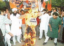Activists of the BJYM burn an effigy of the US Government to protest against denial of visa to Gujarat Chief Minister Narendra Modi in Chandigarh on Monday.