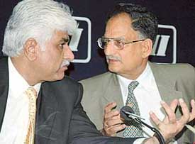 Mr Rakesh Bharti Mittal, Chairman, CII, Northern Region (left), discusses a point with Mr R.C. Dogra, Health & Family Welfare Minister, Punjab, at a conference at CII in Chandigarh on Monday. 