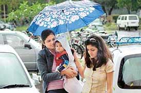 Rain in the city on Monday forced residents to take out umbrellas. 