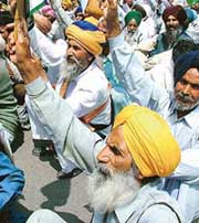 Farmers from Punjab under the banner of Bhartiya Kisan Union (Ekta), Punjab, participate in a rally against World Trade Organisation (WTO) at Parliament Street in New Delhi on Tuesday. 