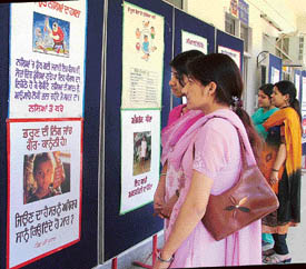 Visitors at an exhibition put up by the health authorities on female foeticide at Master Tara Singh Memorial College, Ludhiana, on Wednesday. 