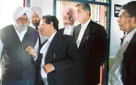 Justice H.S. Bedi interacts with District and Sessions Judge Harbans Lal at district courts in Ludhiana on Wednesday.