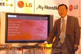 President, South West Asia of LG Electronics pose for a photograph in front of MyHomeNet, the complete home entertainment solution during a press conference in New Delhi