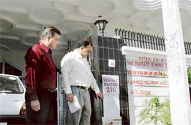Officials of the Oriental Bank of Commerce seal the residence of Pritam Singh Deol