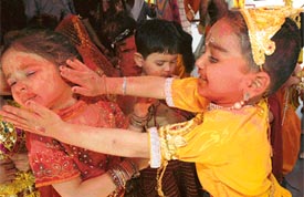 Students of Disney Land play Holi on the school premises in Ludhiana on Thursday