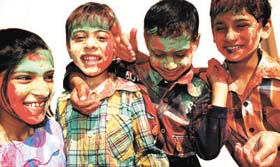 Children celebrating the festival of colours in the Capital