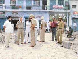 Police posted outside the religious place following tension in Transport Nagar
