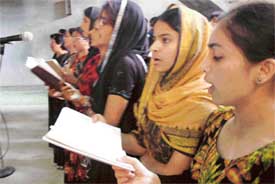 Christians sing hymns during a prayer service in Kalvari Church on Good Friday