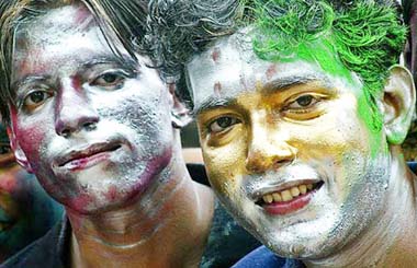 Boys with painted faces celebrate Holi in Kolkata on Friday