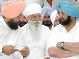 Capt Amarinder Singh talks to Mr Partap Singh Bajwa at Anandpur Sahib on Friday. Mr H.S. Hanspal (centre), President, PPCC, looks on.
