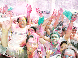 Holi revellers paint the town red with artificially coloured snow and synthetic paints in Sector 20 on Saturday.