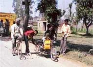 Stickers being affixed on vehicles on the Pohir road Ahmedgarh