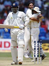 Pakistans Shahid Afridi celebrates with Younis Khan after taking the wicket of Anil Kumble on the fourth day of the third Test in Bangalore 