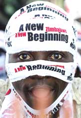 A supporter of Zimbabwean Movement for Democratic Change looks towards their leader Morgan Tsvangirai during an election rally in Harare